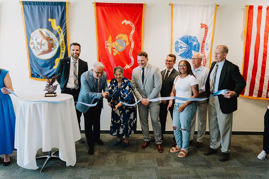 Campus leaders and 学生 cut the ribbon on a new Student Veteran Center.